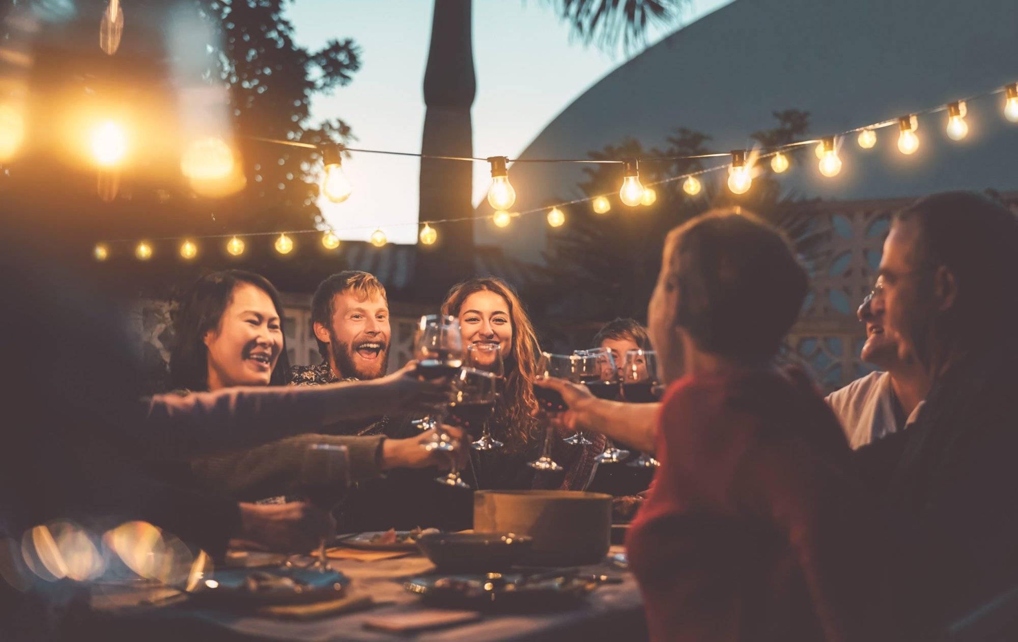 Happy family dining and tasting red wine glasses in barbecue dinner party – People with different ages and ethnicity having fun together – Youth and elderly parents and food weekend activities concept Happy family dining and tasting red wine glasses in barbecue dinner party - People with different ages and ethnicity having fun together - Youth and elderly parents and food weekend activities concept