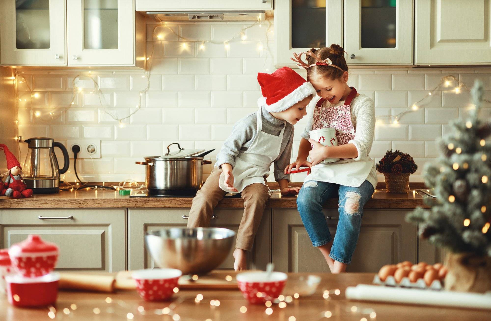 happy children boy and girl bake christmas cookies